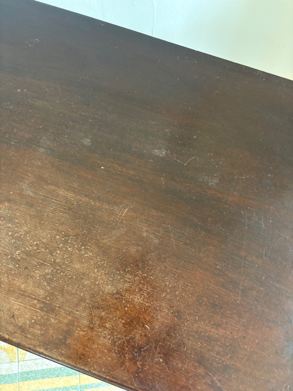A George III style mahogany lowboy table featuring three drawers with decorative brass handles and an arched apron. View IX