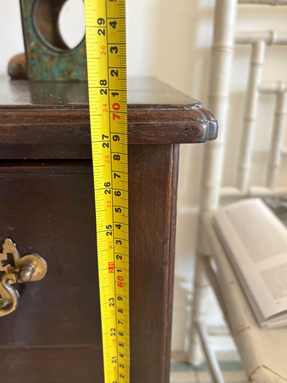 A George III style mahogany lowboy table featuring three drawers with decorative brass handles and an arched apron. View XIII