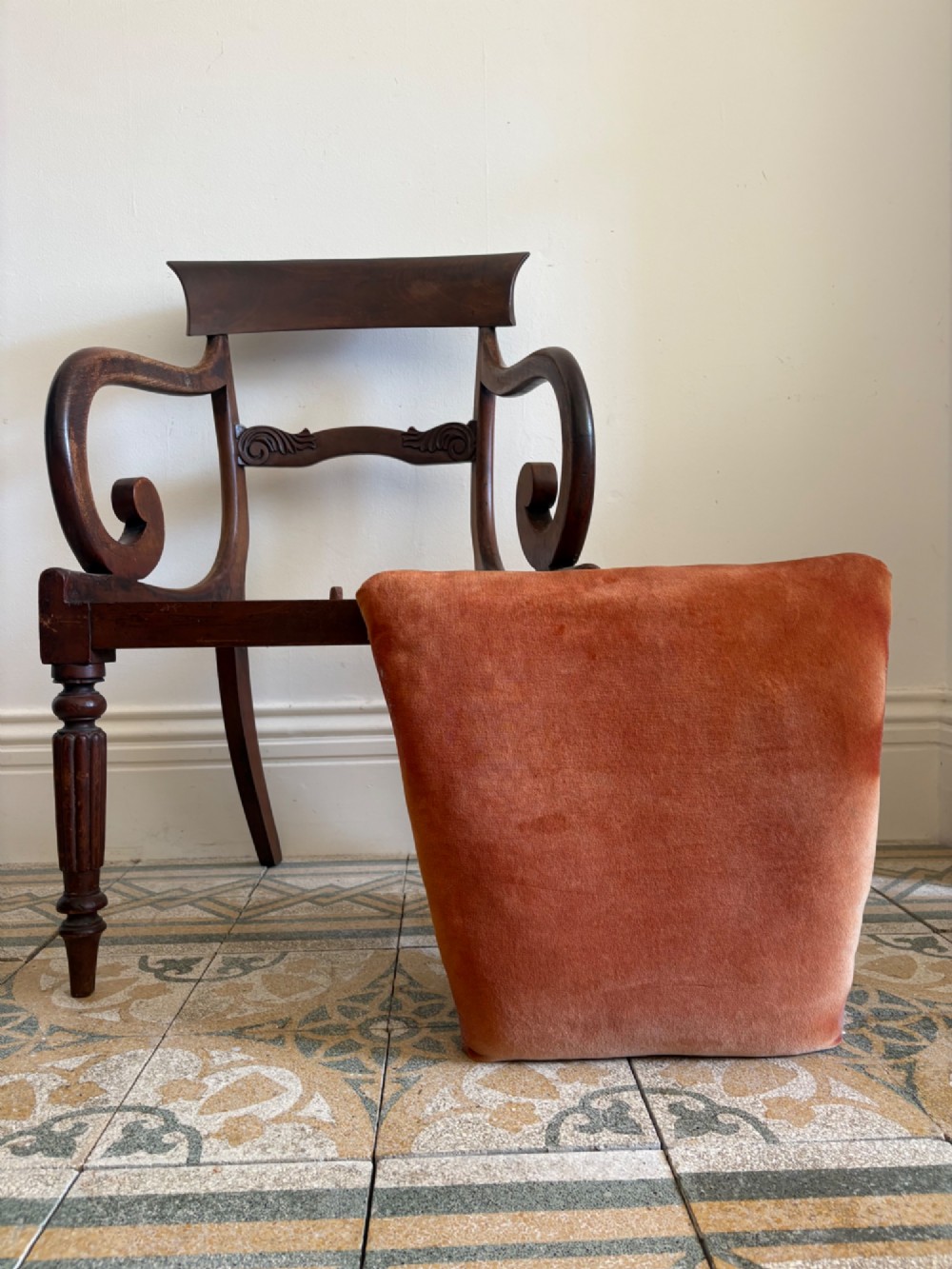 Profile view of a Late Regency mahogany open armchair with scrolled armrests, reeded front legs, and a rust orange velvet drop-in seat. View VII