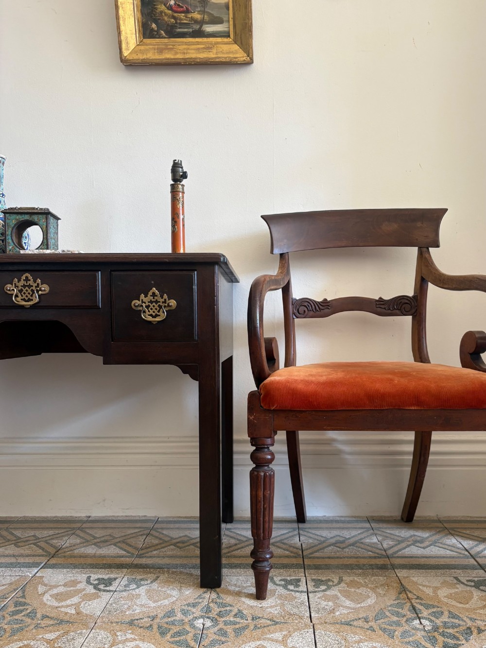 Profile view of a Late Regency mahogany open armchair with scrolled armrests, reeded front legs, and a rust orange velvet drop-in seat. View XIV
