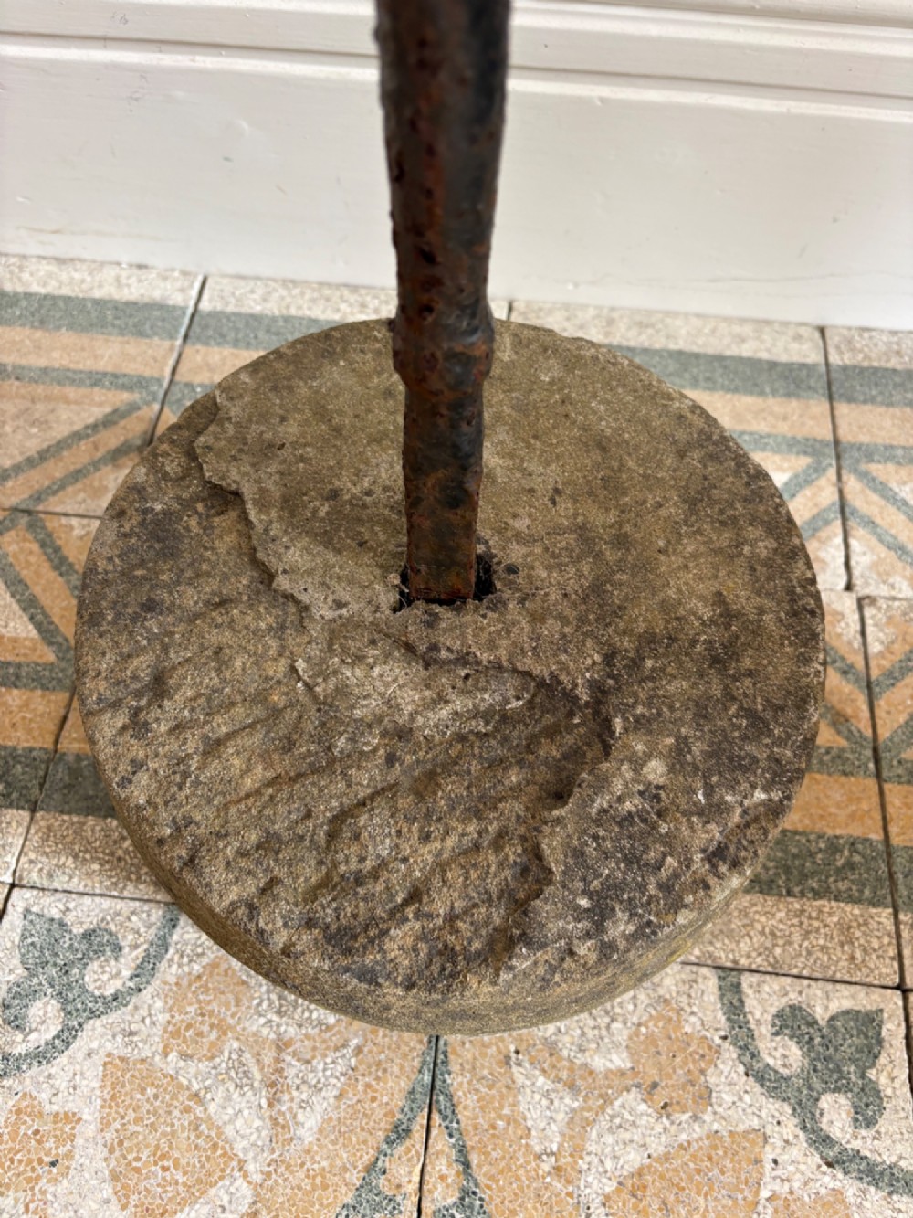 An 18th-century cylindrical carved stone weight featuring an upright hand-forged iron handle attachment. View IV