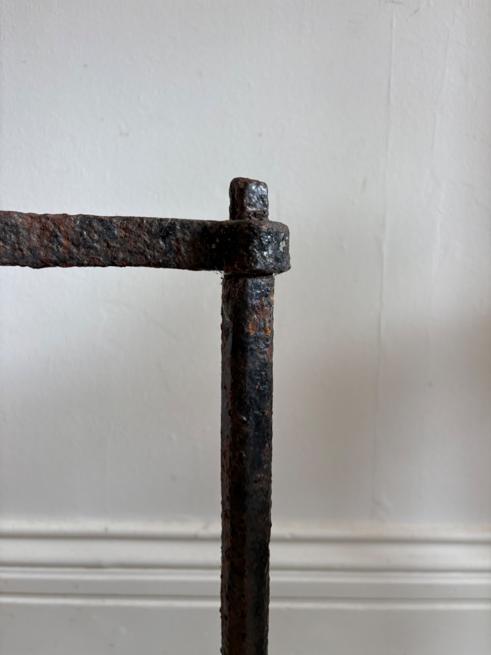 An 18th-century cylindrical carved stone weight featuring an upright hand-forged iron handle attachment. View VII