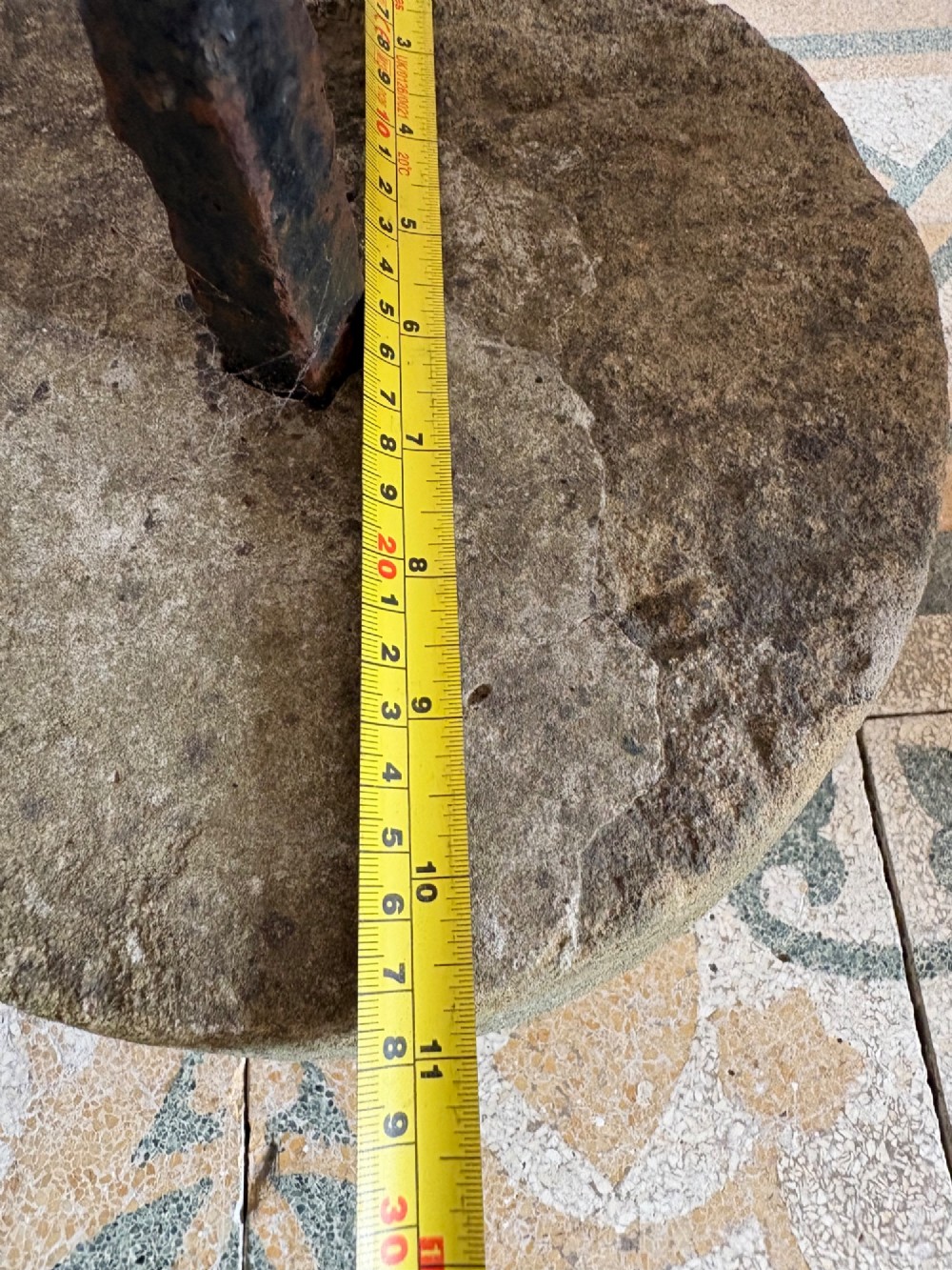 An 18th-century cylindrical carved stone weight featuring an upright hand-forged iron handle attachment. View XI