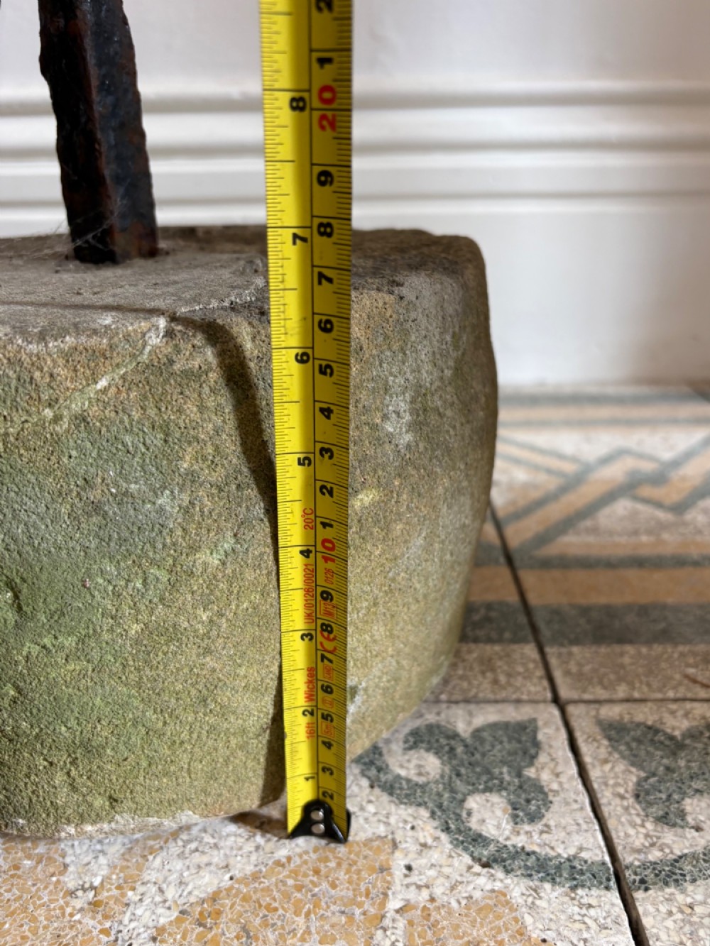 An 18th-century cylindrical carved stone weight featuring an upright hand-forged iron handle attachment. View XII