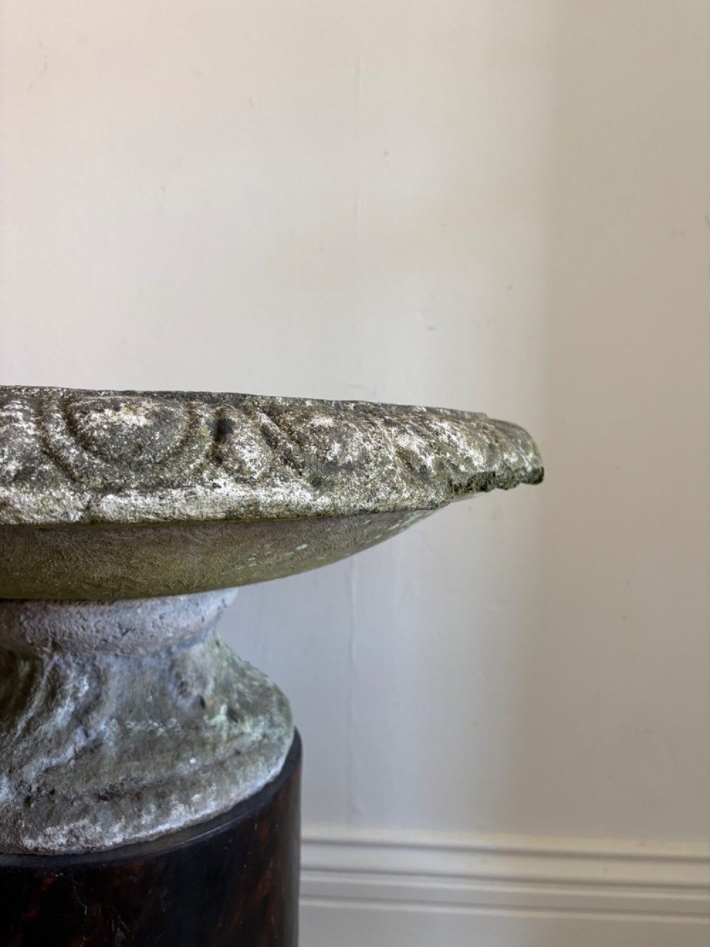 A shallow Neoclassical cast stone birdbath planter with a low moulded pedestal base, displaying a weathered grey and green patinated surface. View VI