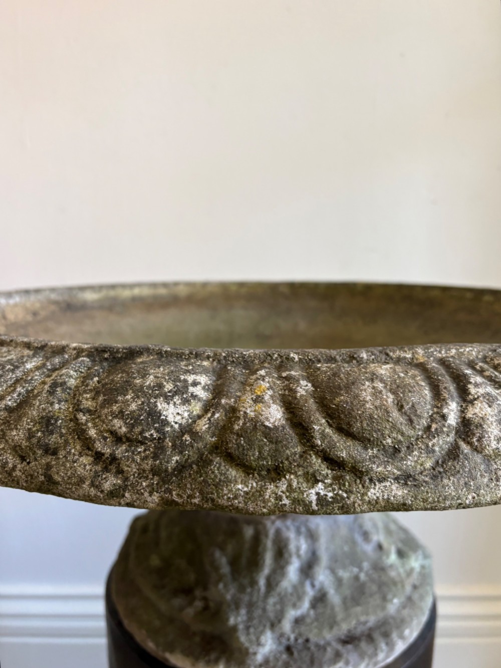 A shallow Neoclassical cast stone birdbath planter with a low moulded pedestal base, displaying a weathered grey and green patinated surface. View VII