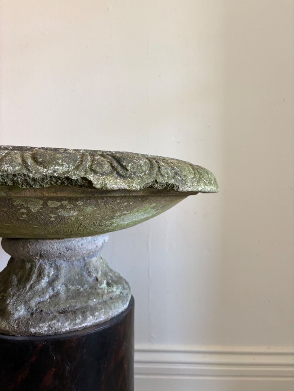 A shallow Neoclassical cast stone birdbath planter with a low moulded pedestal base, displaying a weathered grey and green patinated surface. View VIII