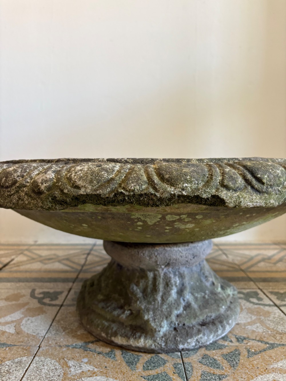 A shallow Neoclassical cast stone birdbath planter with a low moulded pedestal base, displaying a weathered grey and green patinated surface. View XI