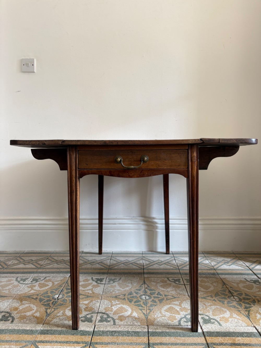 A Georgian mahogany drop-leaf Pembroke table featuring a shaped apron and tapered square legs. View II