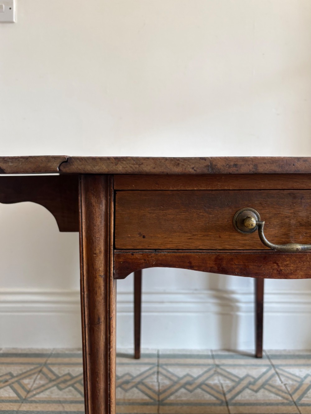 A Georgian mahogany drop-leaf Pembroke table featuring a shaped apron and tapered square legs. View III