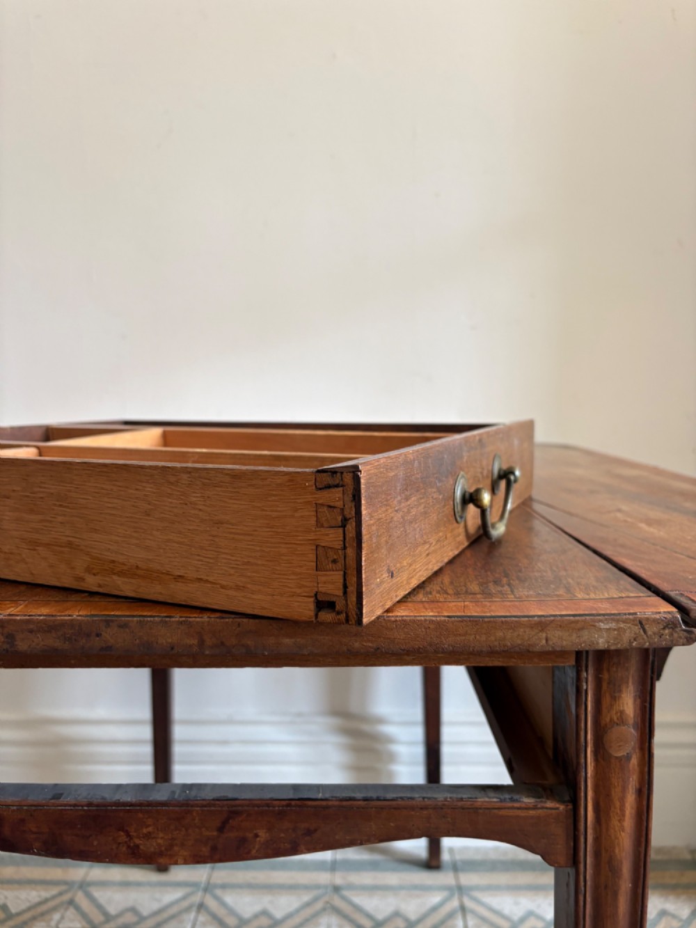 A Georgian mahogany drop-leaf Pembroke table featuring a shaped apron and tapered square legs. View V