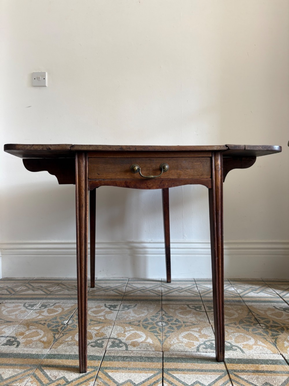 A Georgian mahogany drop-leaf Pembroke table featuring a shaped apron and tapered square legs. View VI