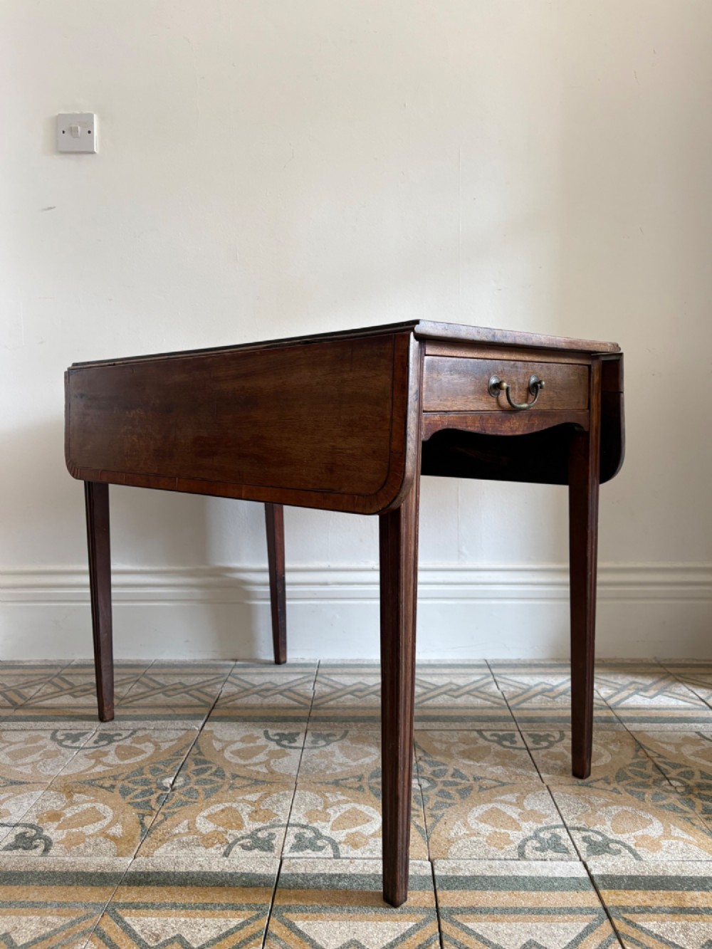 A Georgian mahogany drop-leaf Pembroke table featuring a shaped apron and tapered square legs. View VII