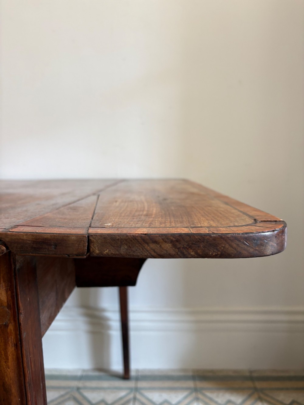 A Georgian mahogany drop-leaf Pembroke table featuring a shaped apron and tapered square legs. View IX