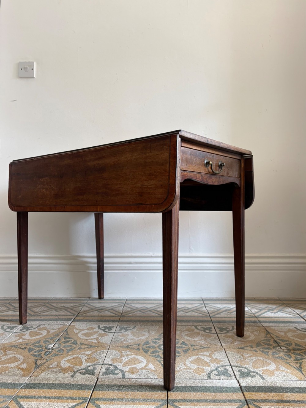 A Georgian mahogany drop-leaf Pembroke table featuring a shaped apron and tapered square legs. View X