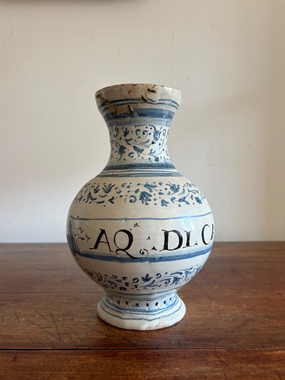 An 18th to 19th century Italian blue and white tin-glazed earthenware apothecary jar featuring painted foliate borders and the Latin inscription CARDO SANT. View XI