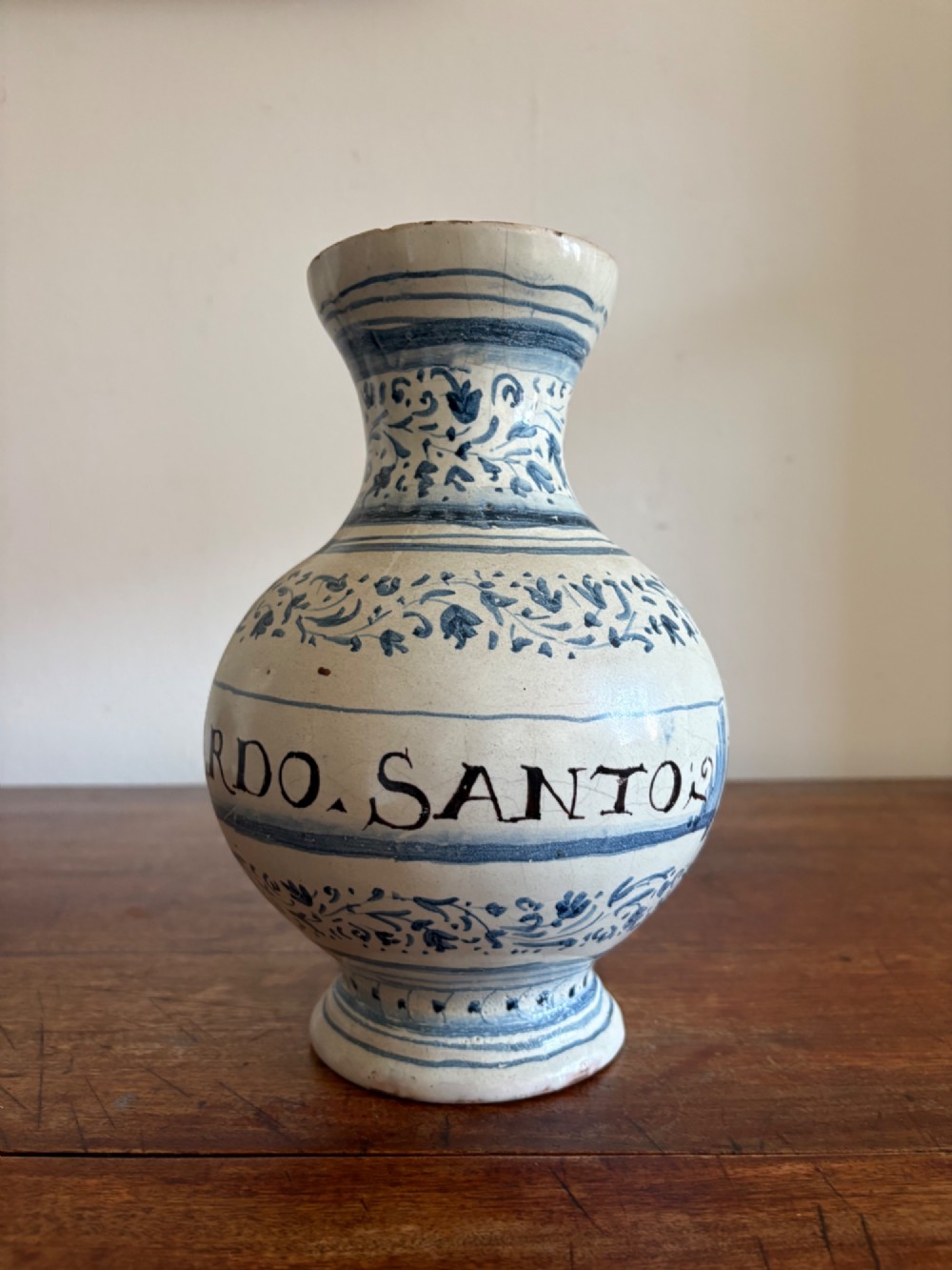 An 18th to 19th century Italian blue and white tin-glazed earthenware apothecary jar featuring painted foliate borders and the Latin inscription CARDO SANT. View XII