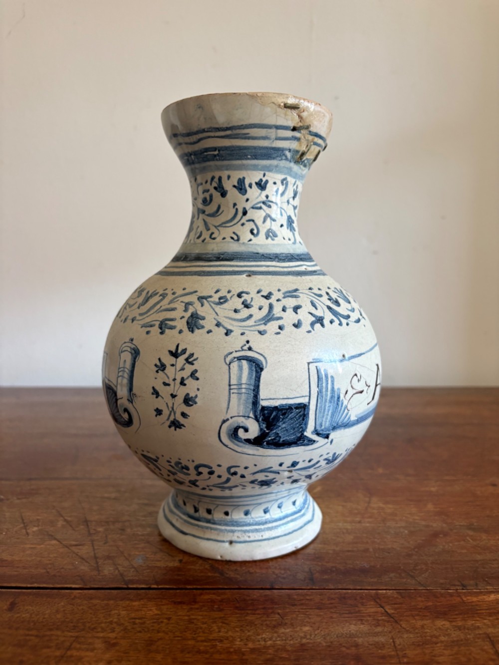 An 18th to 19th century Italian blue and white tin-glazed earthenware apothecary jar featuring painted foliate borders and the Latin inscription CARDO SANT. View XIII