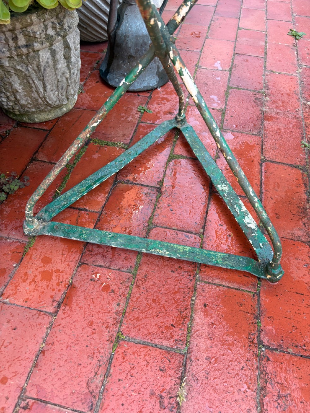 A 19th-century French cast iron gueridon round table featuring distressed green paint and a triangular tripod base. View XII