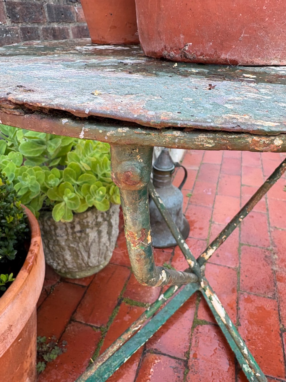 A 19th-century French cast iron gueridon round table featuring distressed green paint and a triangular tripod base. View XIII