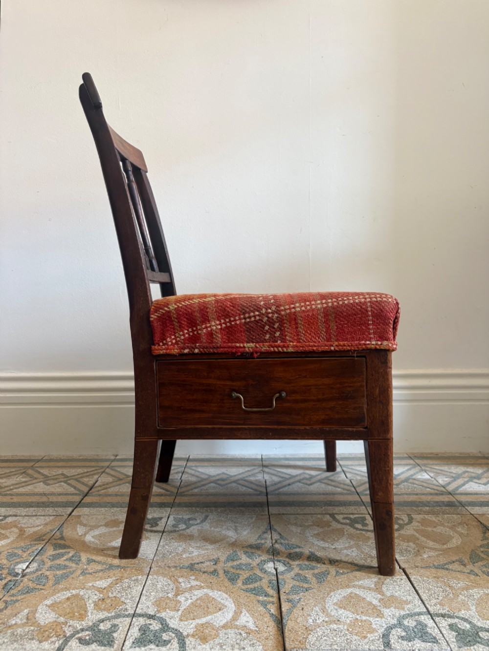 A Regency mahogany and beech side chair featuring a red plaid upholstered seat above an integrated wooden drawer with a brass drop handle. View XV