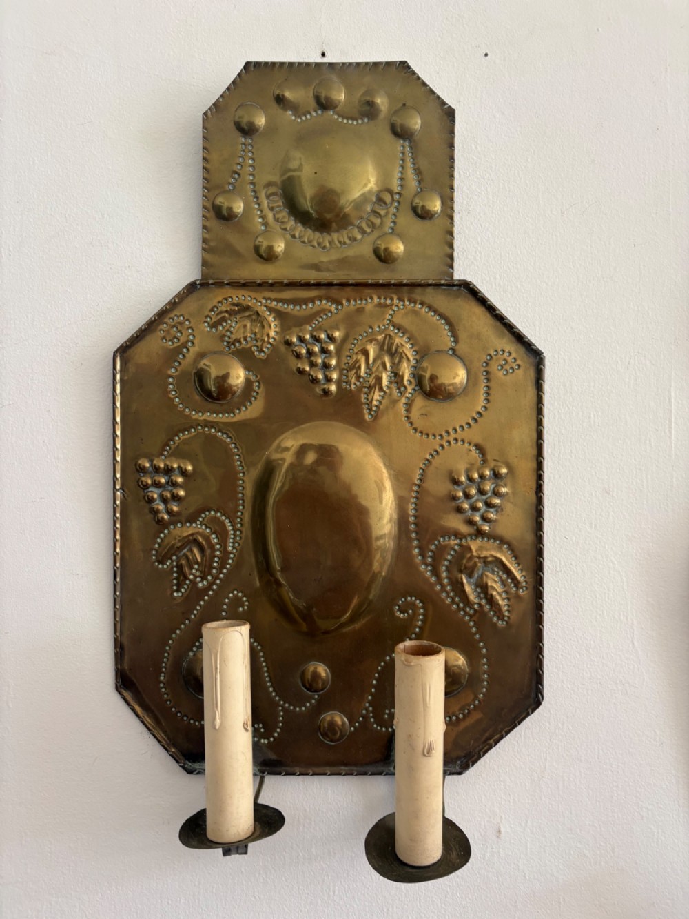 Pair of late 19th-century Dutch repousse brass two-branch wall sconces decorated with embossed grape vine motifs and oval central bosses. View III