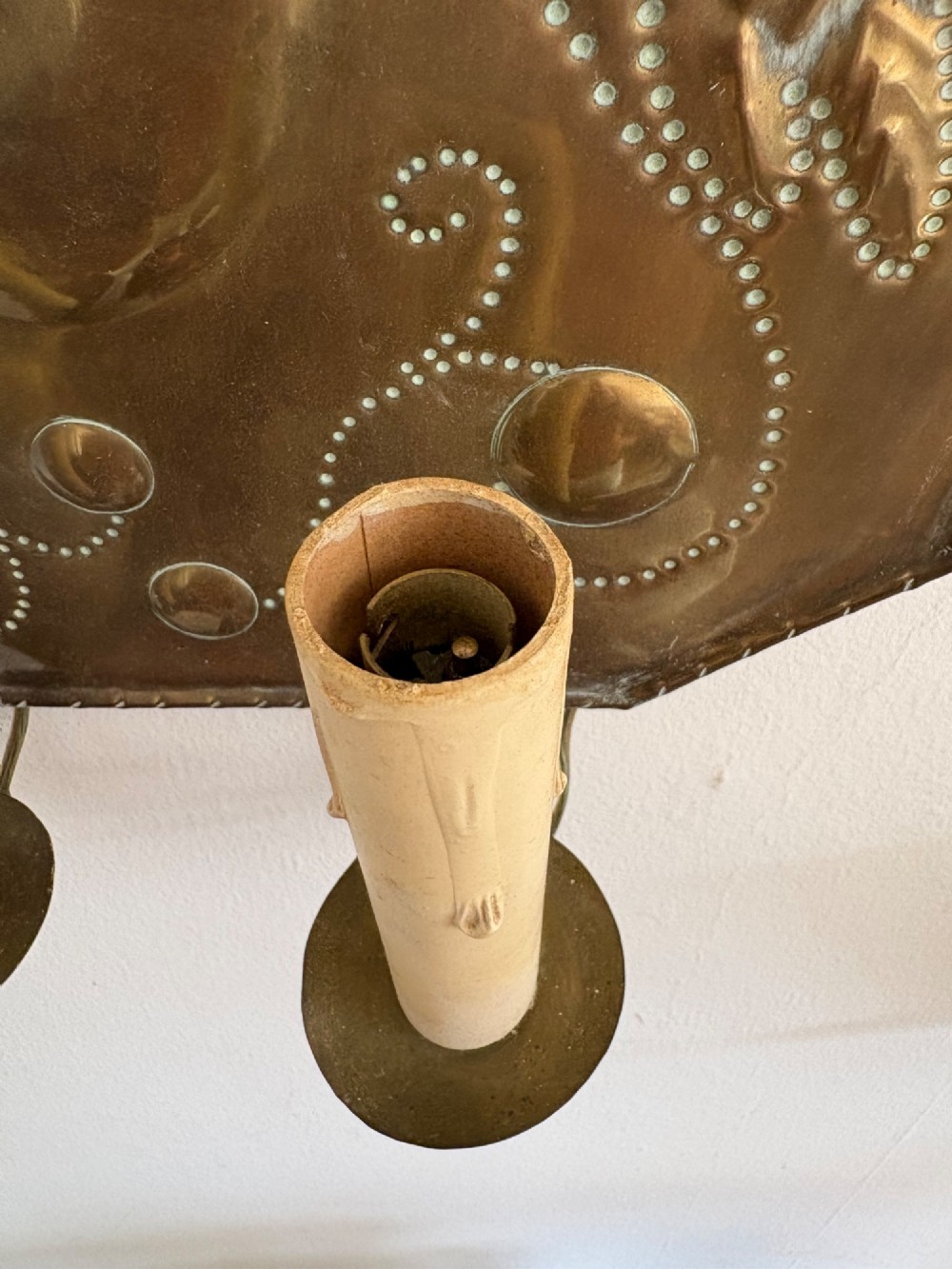 Pair of late 19th-century Dutch repousse brass two-branch wall sconces decorated with embossed grape vine motifs and oval central bosses. View VI