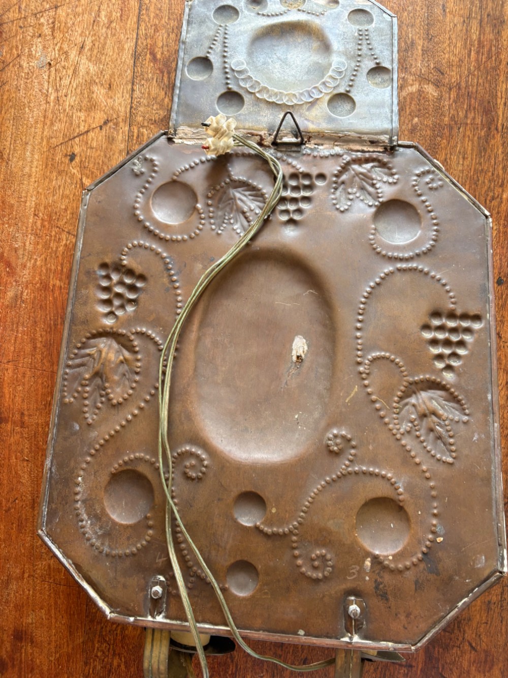 Pair of late 19th-century Dutch repousse brass two-branch wall sconces decorated with embossed grape vine motifs and oval central bosses. View IX