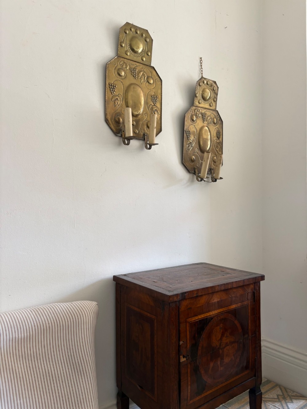 Pair of late 19th-century Dutch repousse brass two-branch wall sconces decorated with embossed grape vine motifs and oval central bosses. View XII