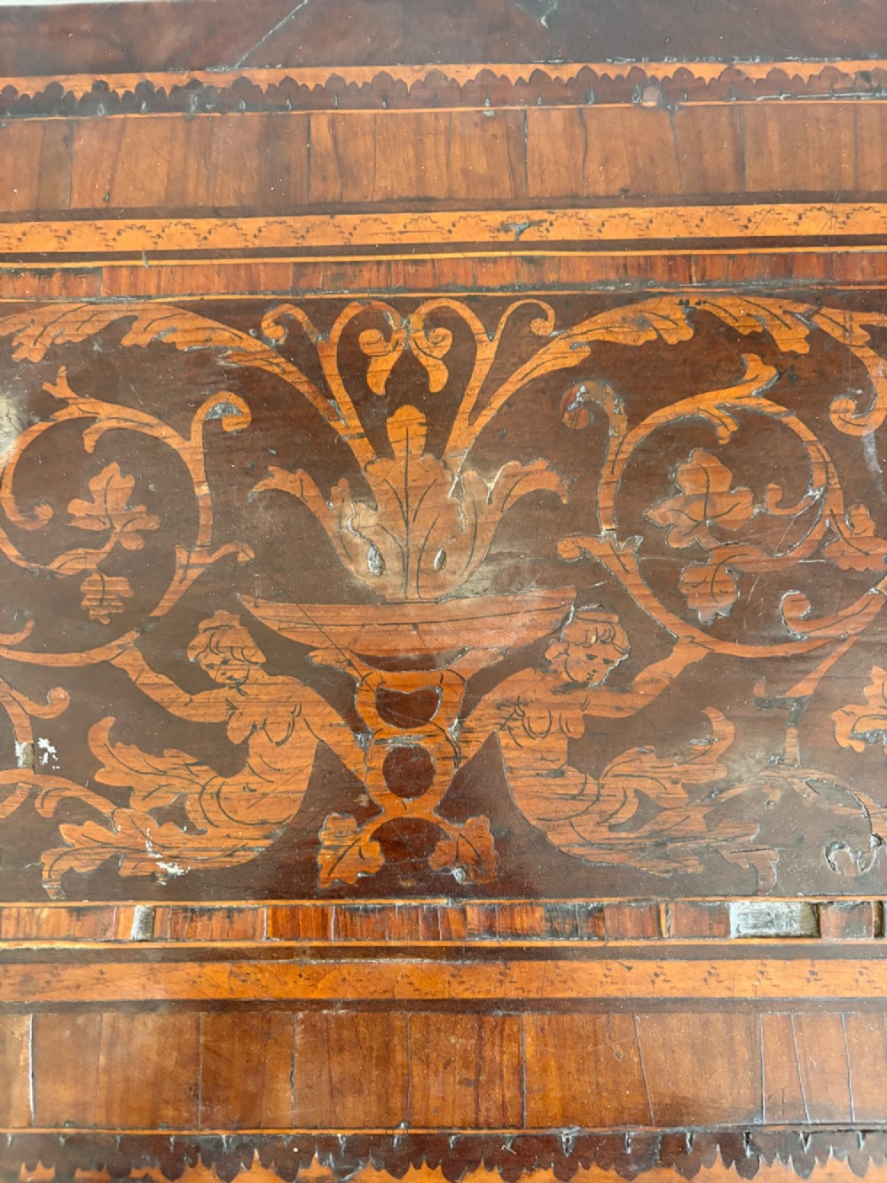 An 18th-century Italian Neoclassical walnut bedside cabinet featuring a central circular figurative marquetry panel on the front door, supported by square tapered legs. View VI
