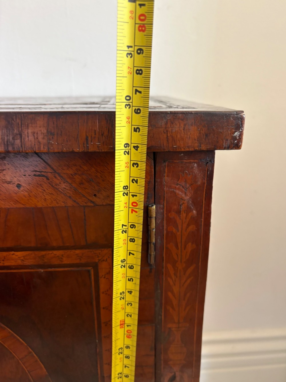 An 18th-century Italian Neoclassical walnut bedside cabinet featuring a central circular figurative marquetry panel on the front door, supported by square tapered legs. View XI