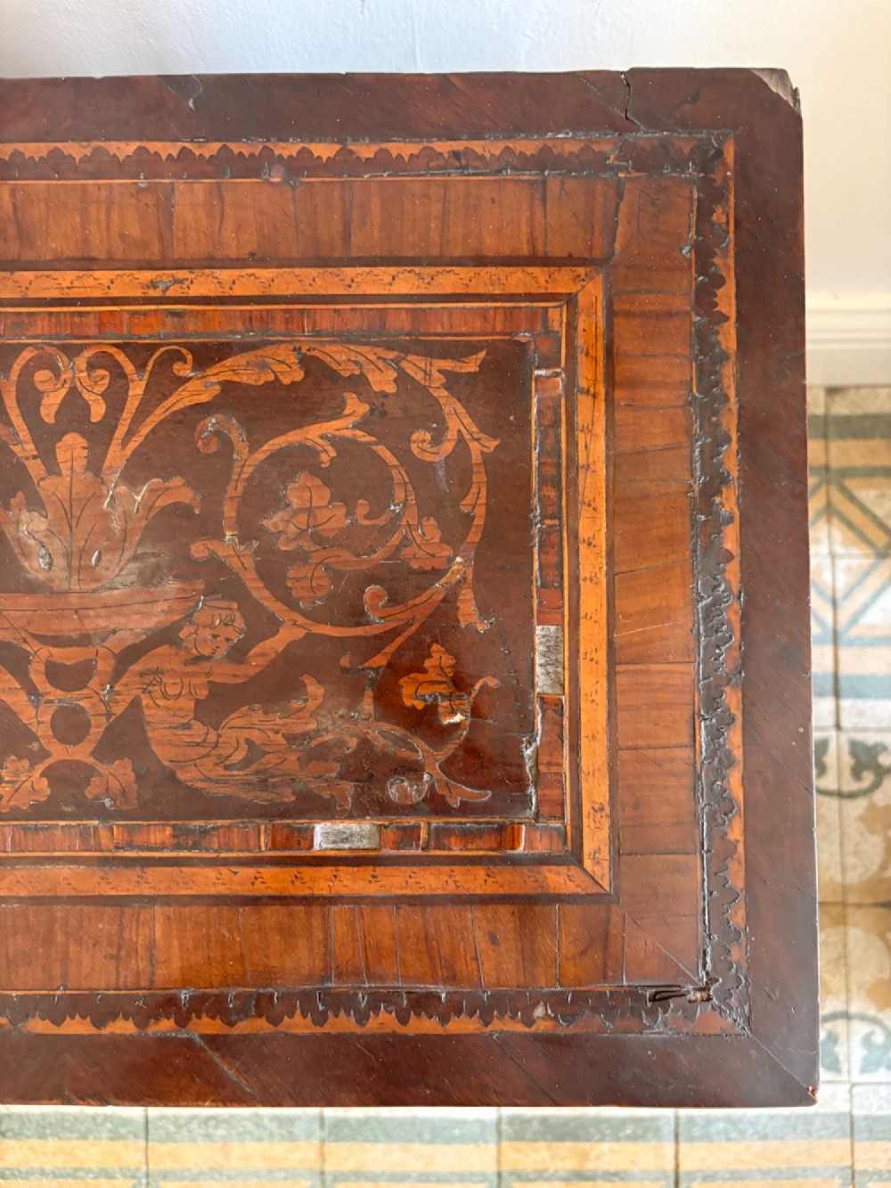 An 18th-century Italian Neoclassical walnut bedside cabinet featuring a central circular figurative marquetry panel on the front door, supported by square tapered legs. View XV