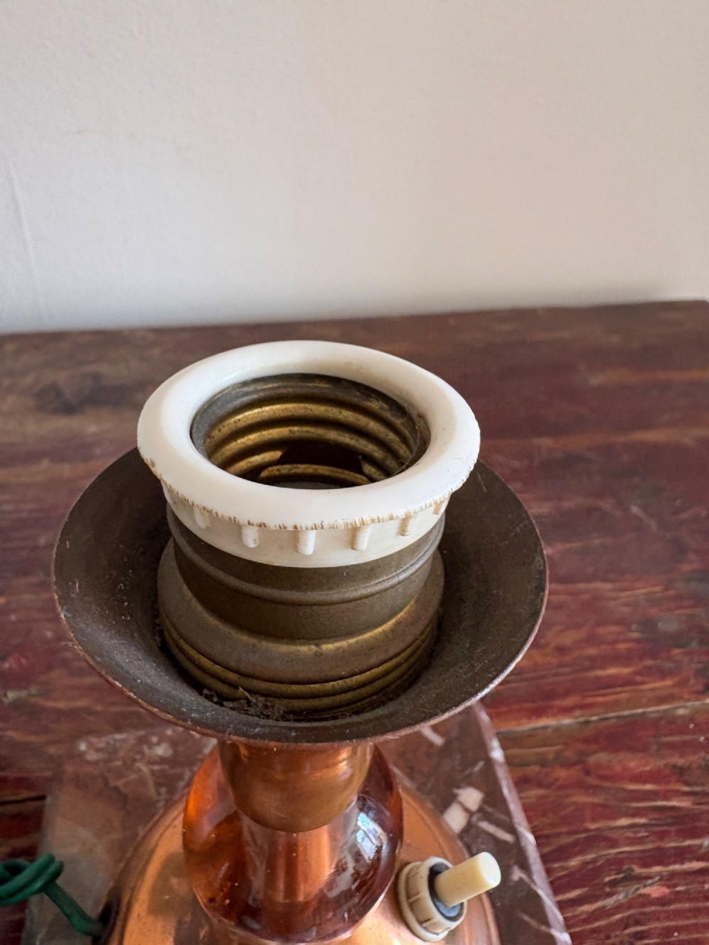 A small French Art Deco table lamp featuring a spherical white opaline glass shade atop a turned copper stem mounted on a square veined marble base. View VI