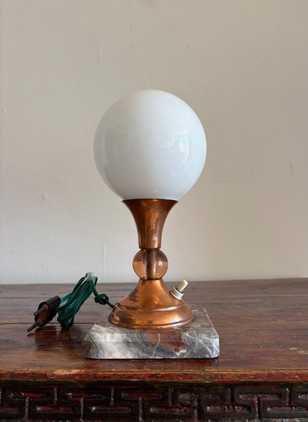 A small French Art Deco table lamp featuring a spherical white opaline glass shade atop a turned copper stem mounted on a square veined marble base. View VIII