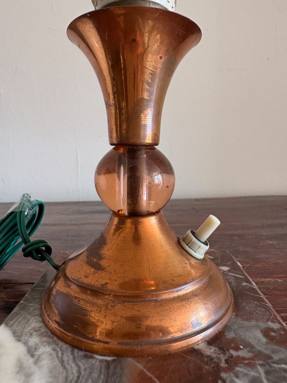 A small French Art Deco table lamp featuring a spherical white opaline glass shade atop a turned copper stem mounted on a square veined marble base. View IX