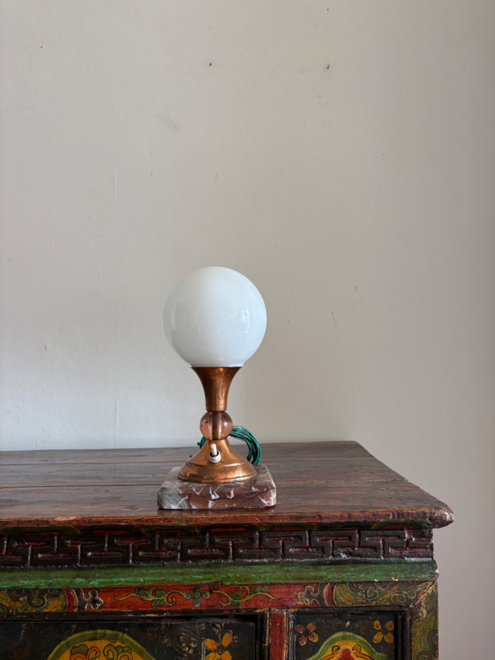 A small French Art Deco table lamp featuring a spherical white opaline glass shade atop a turned copper stem mounted on a square veined marble base. View XI