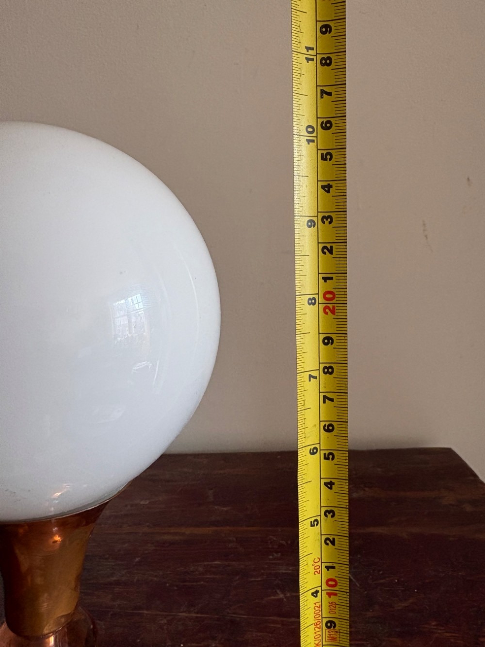 A small French Art Deco table lamp featuring a spherical white opaline glass shade atop a turned copper stem mounted on a square veined marble base. View XII