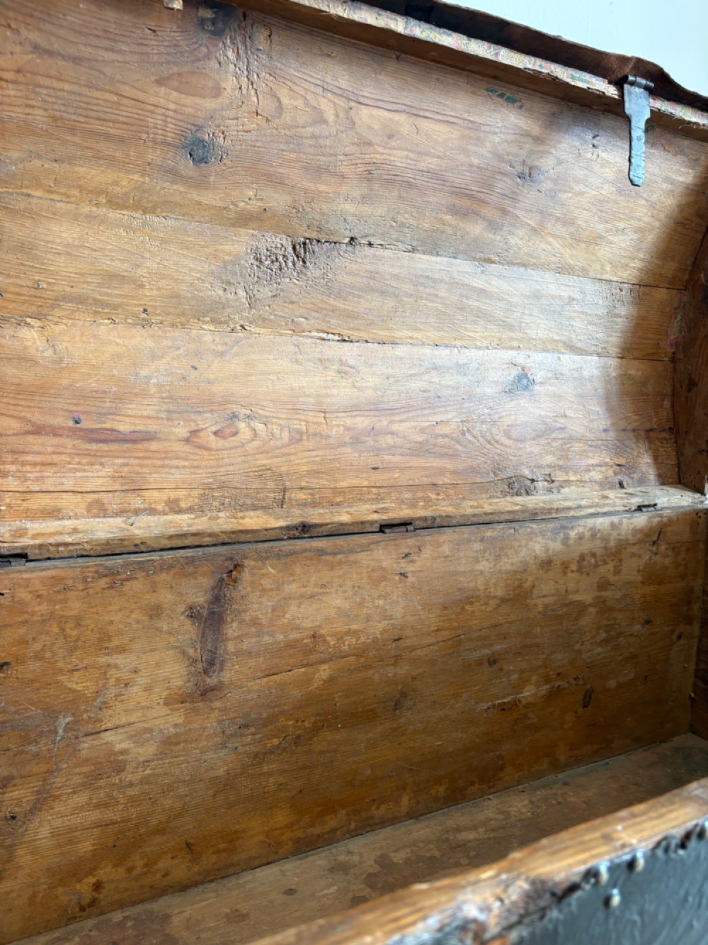 An 18th-century Dutch dark brown leather trunk featuring a domed lid, intricate brass studding in scrolling floral patterns, and iron lock hardware. View X