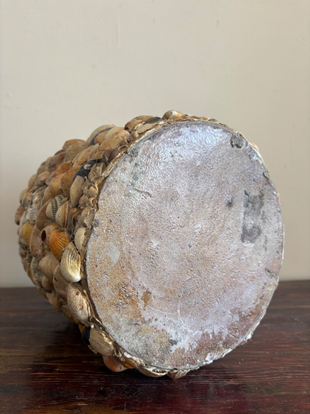 A cylindrical antique vase completely encrusted with an assortment of natural sea shells set into a mortar matrix. View IV