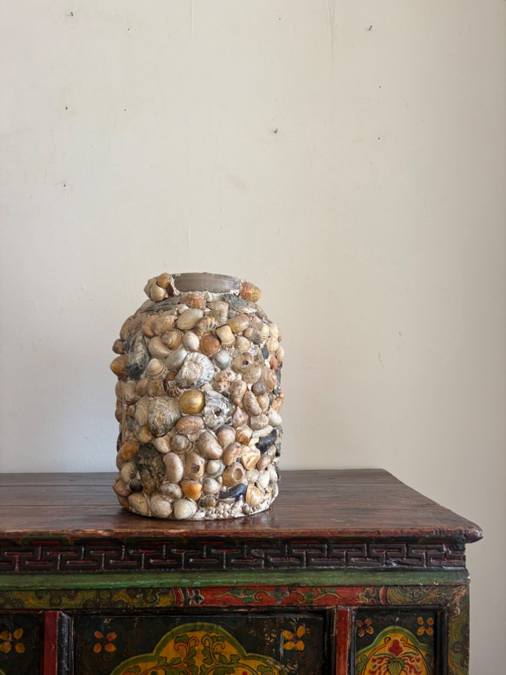 A cylindrical antique vase completely encrusted with an assortment of natural sea shells set into a mortar matrix. View IX