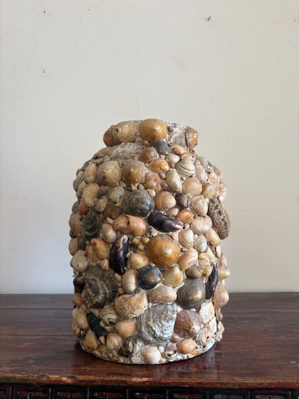 A cylindrical antique vase completely encrusted with an assortment of natural sea shells set into a mortar matrix. View XIII