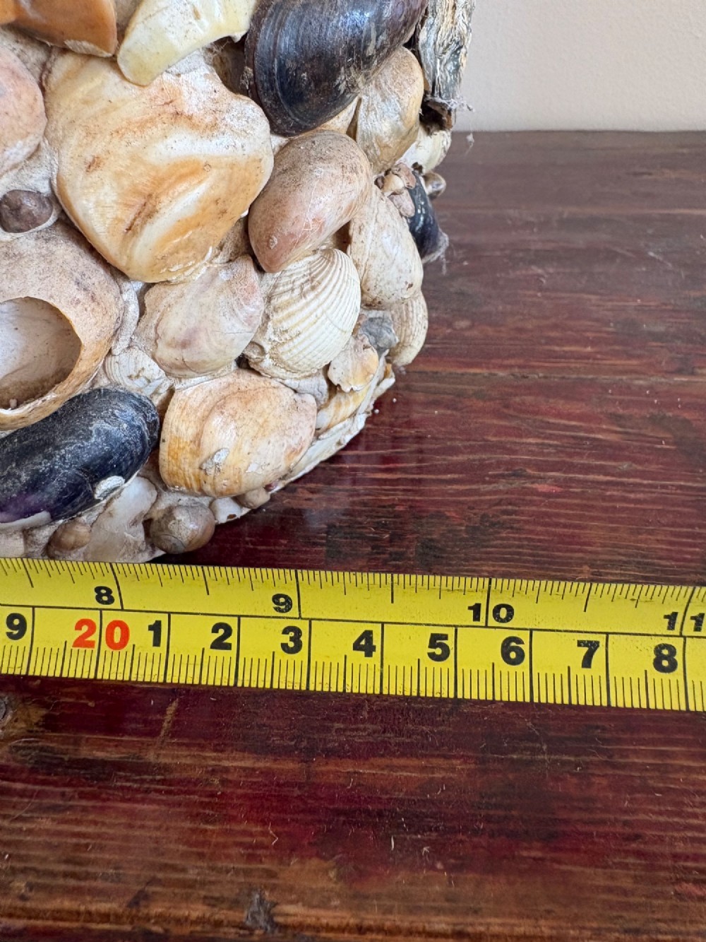 A cylindrical antique vase completely encrusted with an assortment of natural sea shells set into a mortar matrix. View XV
