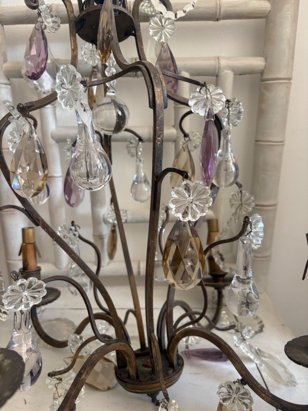 A four-branch French Rococo style gilt bronze chandelier decorated with clear, grey, and violet crystal drops. View VI