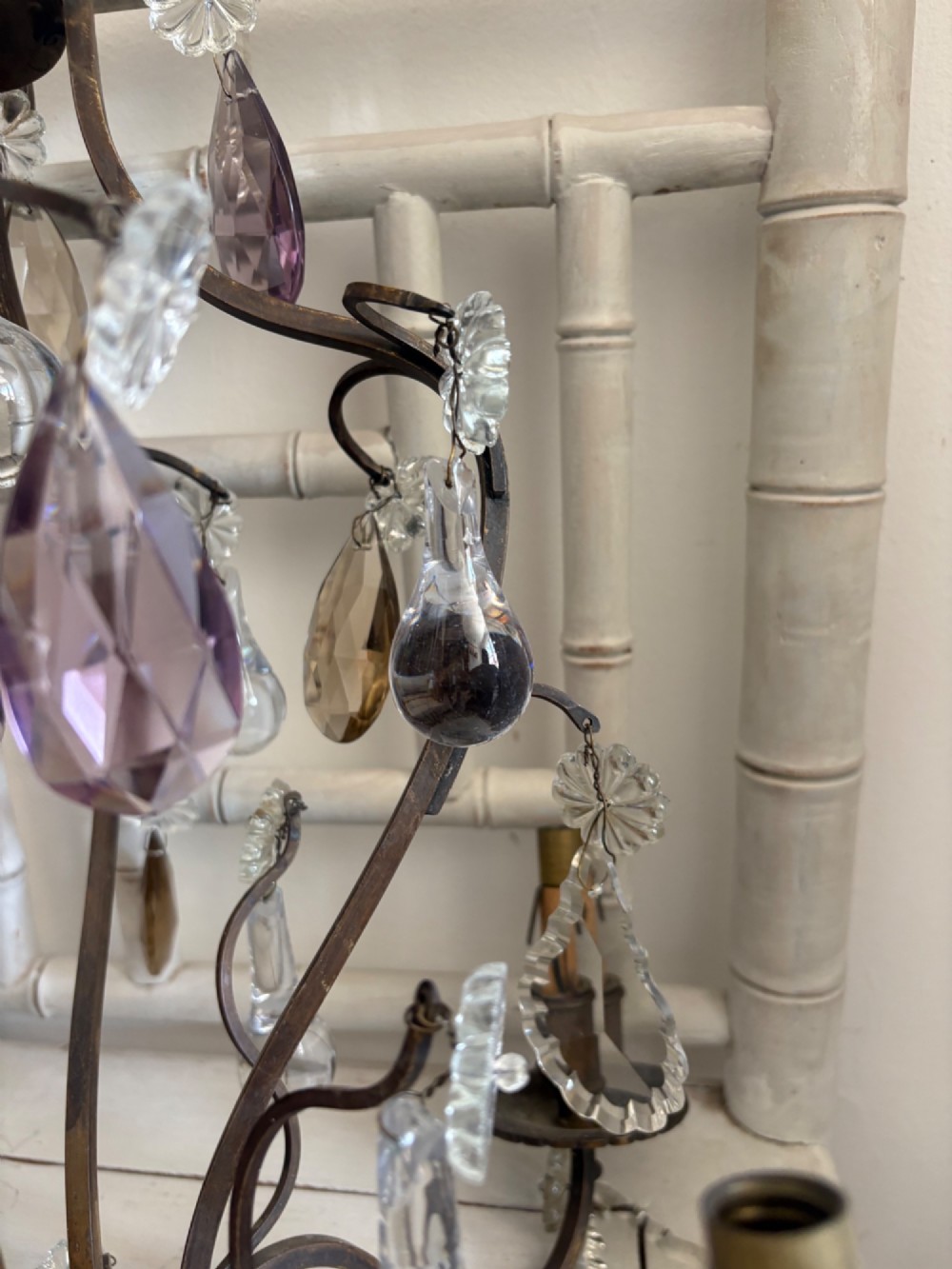 A four-branch French Rococo style gilt bronze chandelier decorated with clear, grey, and violet crystal drops. View VIII