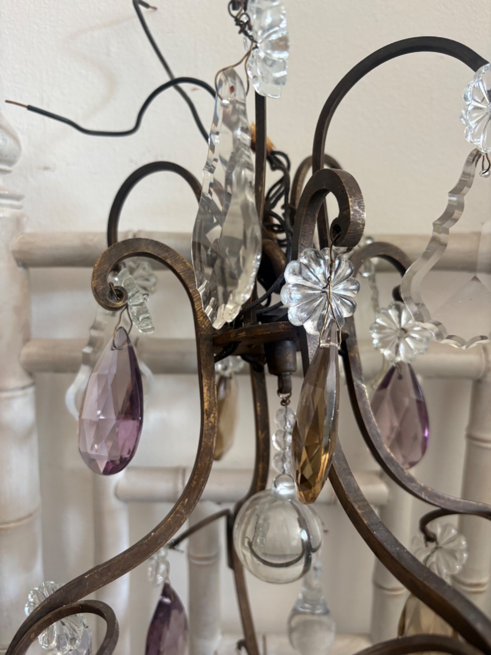 A four-branch French Rococo style gilt bronze chandelier decorated with clear, grey, and violet crystal drops. View IX