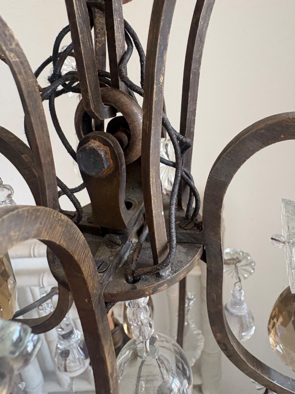 A four-branch French Rococo style gilt bronze chandelier decorated with clear, grey, and violet crystal drops. View X