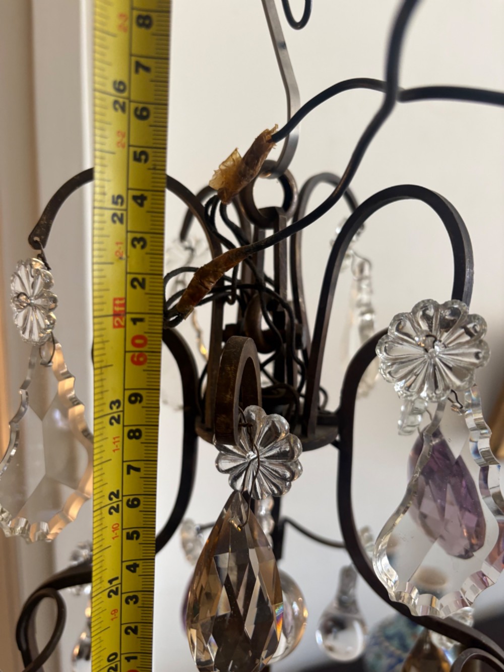 A four-branch French Rococo style gilt bronze chandelier decorated with clear, grey, and violet crystal drops. View XII