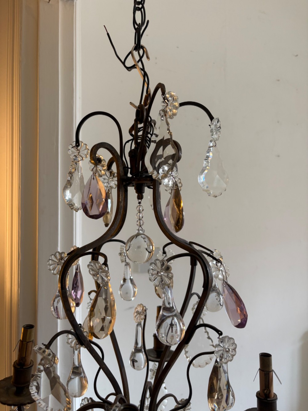 A four-branch French Rococo style gilt bronze chandelier decorated with clear, grey, and violet crystal drops. View XV