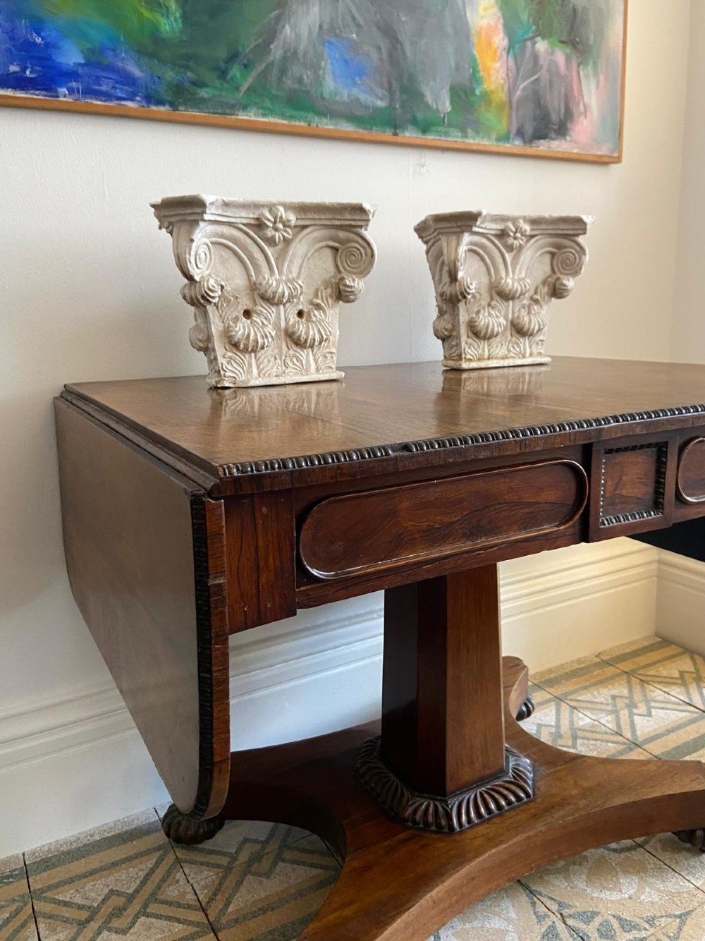 A Regency rosewood sofa table featuring two drop leaves, twin frieze drawers, a central pedestal column, and a quadform base with claw feet. View XIII