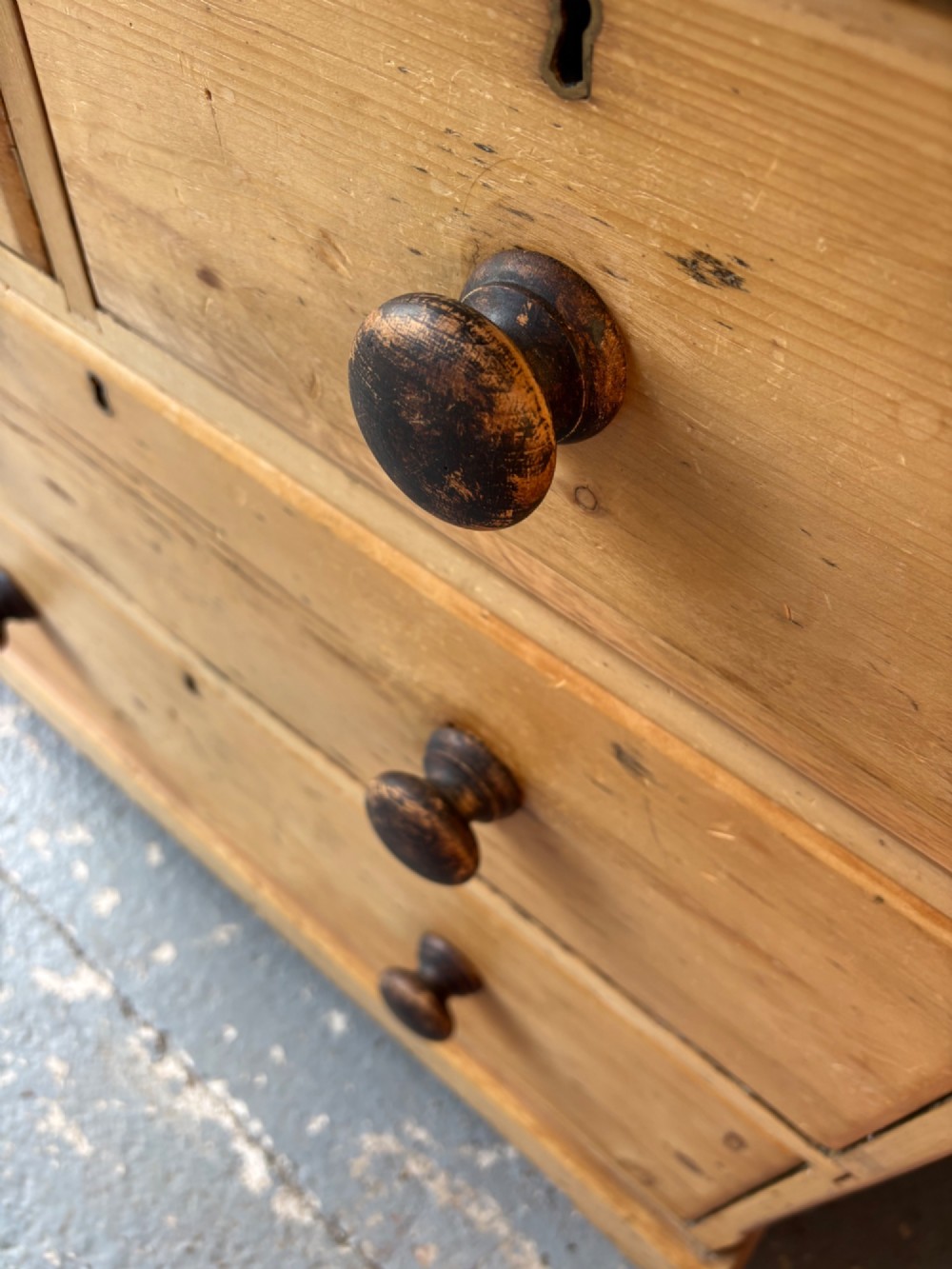 A nineteenth-century scrubbed pine chest of drawers with two small drawers above two long drawers featuring dark turned bun handles. View VII